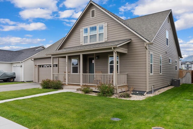 203 Kismet Ct, Hamilton, MT 59840 - view of front facade with a porch, a garage, driveway, roof with shingles, and central AC unit