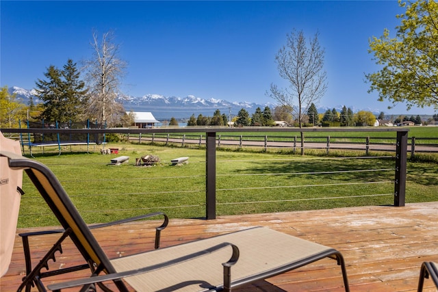 33766 W Shore Dr, Polson, MT 59860 - deck featuring a trampoline, a mountain view, and a view of rural / pastoral area