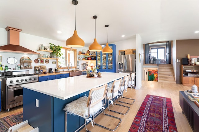 33766 W Shore Dr, Polson, MT 59860 - kitchen with appliances with stainless steel finishes, open shelves, wall chimney exhaust hood, healthy amount of natural light, and recessed lighting