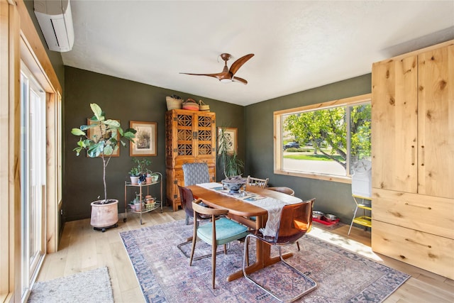 33766 W Shore Dr, Polson, MT 59860 - dining area with an AC wall unit, wood finished floors, and ceiling fan