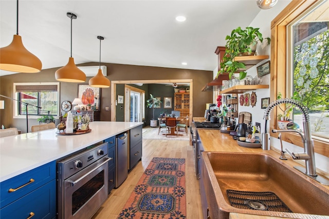 33766 W Shore Dr, Polson, MT 59860 - kitchen featuring blue cabinets, a sink, stainless steel appliances, light wood finished floors, and open shelves