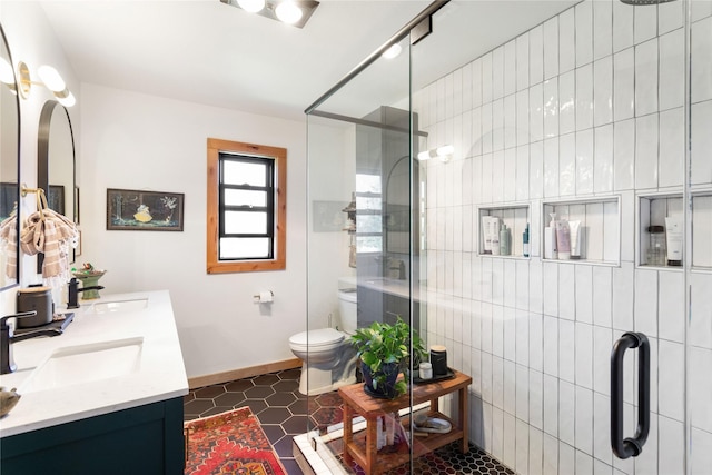 33766 W Shore Dr, Polson, MT 59860 - full bathroom featuring a shower stall, toilet, baseboards, and double vanity