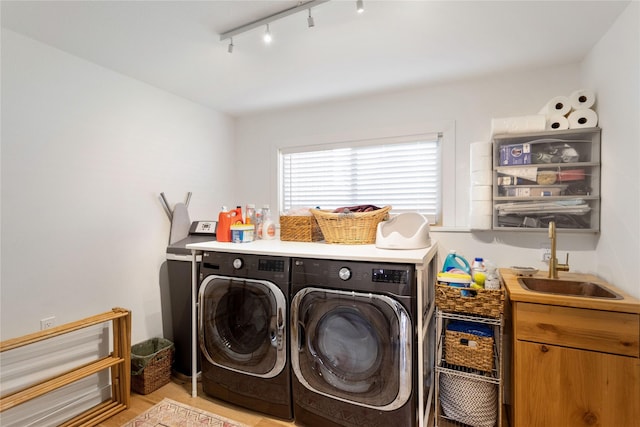 33766 W Shore Dr, Polson, MT 59860 - clothes washing area with washing machine and clothes dryer, rail lighting, and light wood finished floors