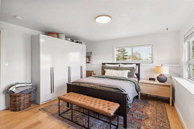 33766 W Shore Dr, Polson, MT 59860 - bedroom with light wood-type flooring and white fridge