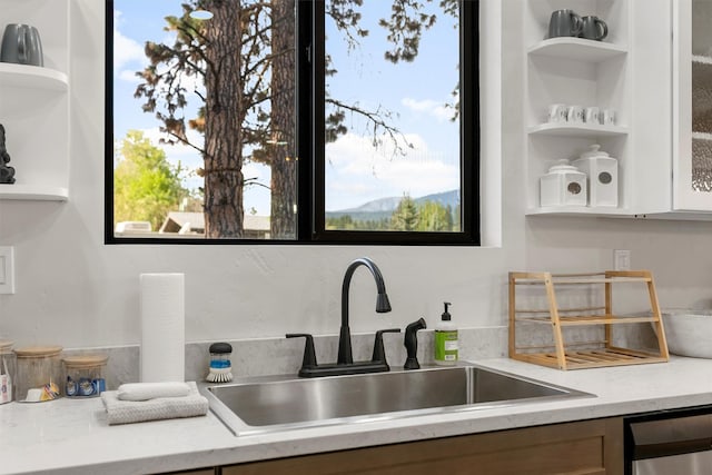 212 Water Way, Darby, MT 59829 - kitchen with a sink, open shelves, dishwashing machine, white cabinetry, and plenty of natural light