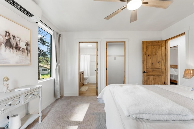 212 Water Way, Darby, MT 59829 - bedroom with a wall mounted AC, baseboards, light colored carpet, connected bathroom, and a ceiling fan