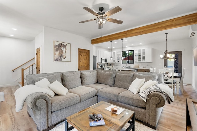 212 Water Way, Darby, MT 59829 - living area featuring light wood-type flooring, a ceiling fan, a chandelier, stairway, and baseboards
