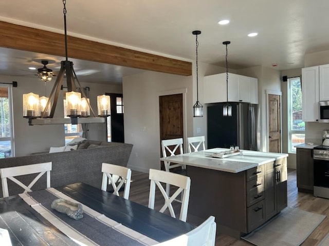 212 Water Way, Darby, MT 59829 - dining area with light wood-type flooring, a chandelier, recessed lighting, a ceiling fan, and beam ceiling