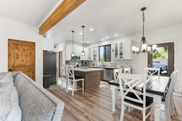 212 Water Way, Darby, MT 59829 - dining space featuring healthy amount of natural light, a chandelier, light wood-style floors, recessed lighting, and beam ceiling