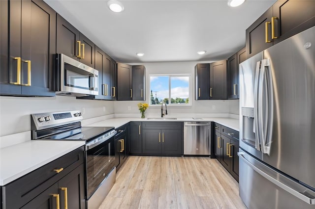 861 9th St W, Kalispell, MT 59901 - kitchen featuring appliances with stainless steel finishes, light wood-type flooring, recessed lighting, and light countertops
