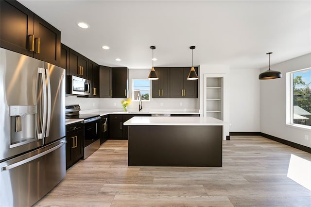 861 9th St W, Kalispell, MT 59901 - kitchen with appliances with stainless steel finishes, light countertops, a kitchen island, recessed lighting, and hanging light fixtures