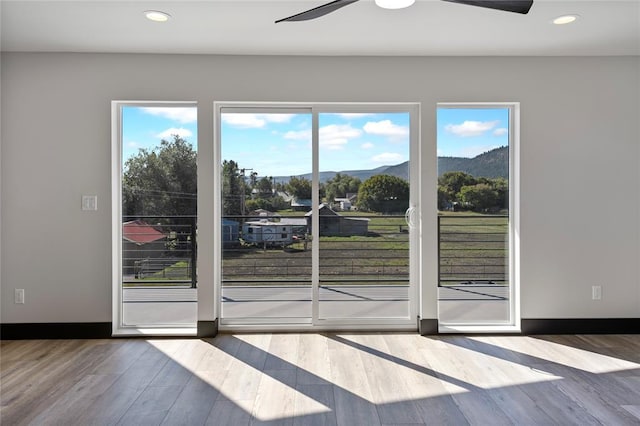 861 9th St W, Kalispell, MT 59901 - doorway featuring a ceiling fan, wood finished floors, a mountain view, and recessed lighting