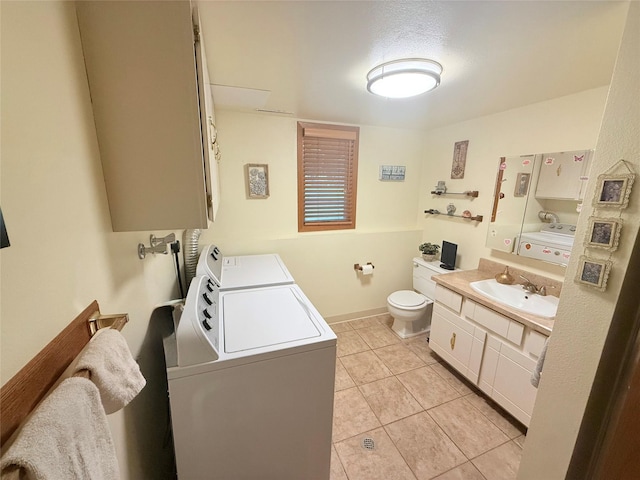 bathroom with washer and clothes dryer, tile patterned flooring, toilet, vanity, and baseboards