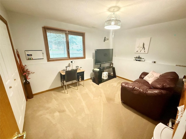 carpeted living area featuring baseboards