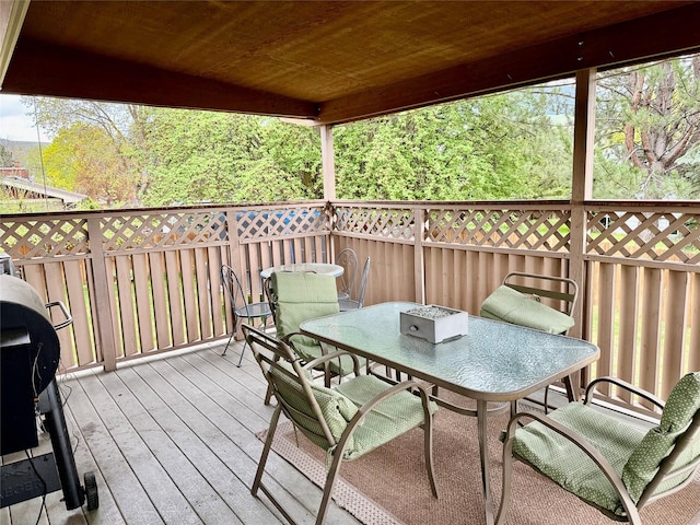 wooden deck featuring outdoor dining space and grilling area