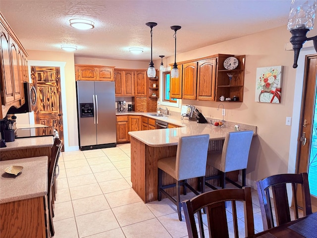 kitchen featuring stainless steel fridge with ice dispenser, open shelves, a peninsula, brown cabinets, and a breakfast bar