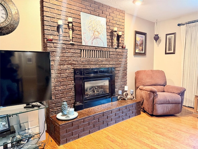 living area featuring a fireplace and wood finished floors