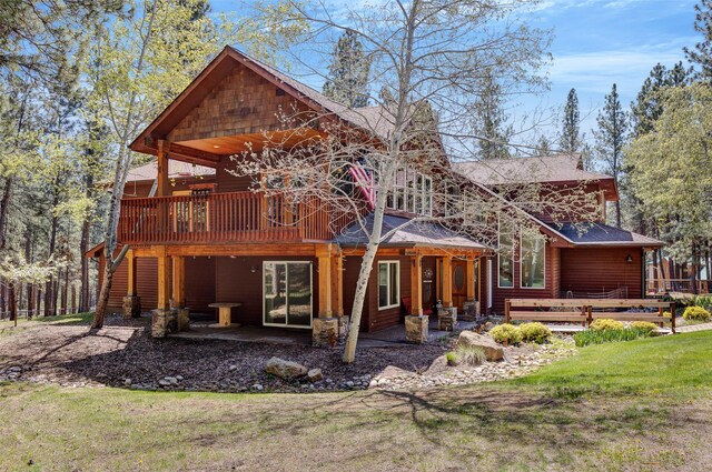 303 Wyant Ln, Hamilton, MT 59840 - back of house with a wooden deck, a patio area, roof with shingles, and a yard