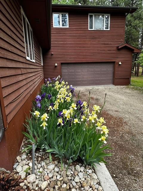 303 Wyant Ln, Hamilton, MT 59840 - view of side of home with an attached garage and driveway