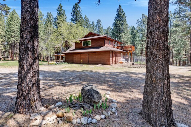 303 Wyant Ln, Hamilton, MT 59840 - view of property exterior with an attached garage and a wooden deck