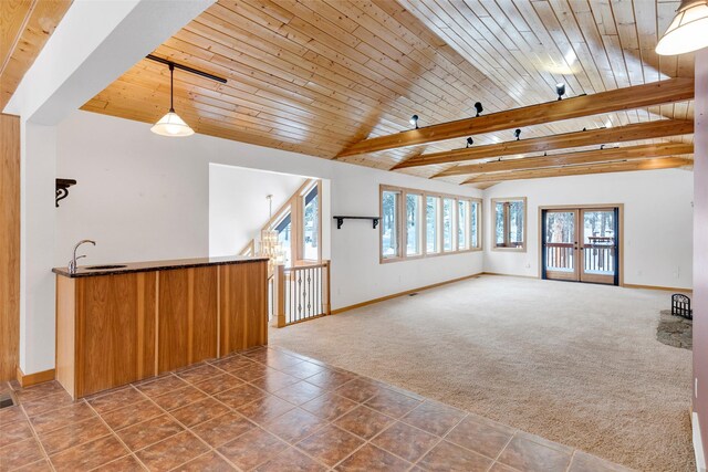 303 Wyant Ln, Hamilton, MT 59840 - unfurnished living room featuring carpet flooring, baseboards, wooden ceiling, french doors, and bar