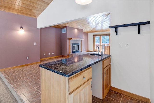 303 Wyant Ln, Hamilton, MT 59840 - kitchen with a sink, wood ceiling, vaulted ceiling, baseboards, and dark tile patterned flooring