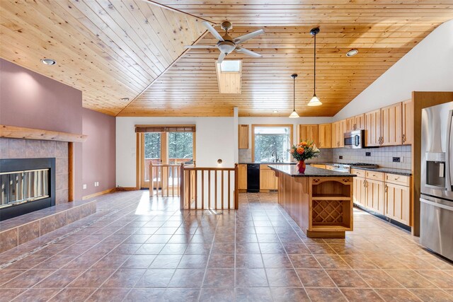 303 Wyant Ln, Hamilton, MT 59840 - kitchen featuring appliances with stainless steel finishes, dark countertops, vaulted ceiling, wood ceiling, and a kitchen island