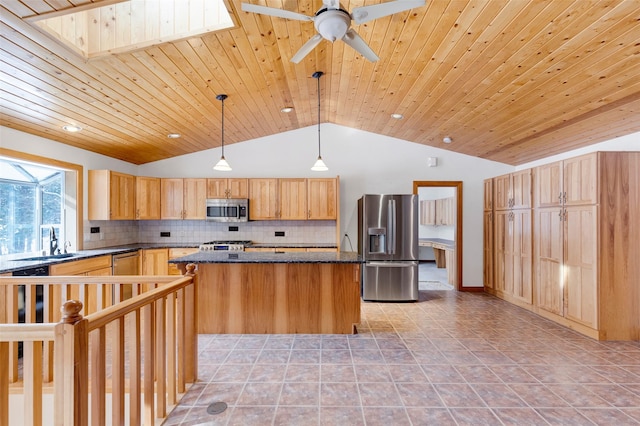 303 Wyant Ln, Hamilton, MT 59840 - kitchen featuring stainless steel appliances, vaulted ceiling, decorative backsplash, a kitchen island, and a ceiling fan