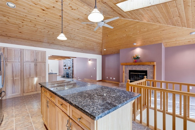 303 Wyant Ln, Hamilton, MT 59840 - kitchen featuring a tiled fireplace, wood ceiling, ceiling fan, high vaulted ceiling, and a center island