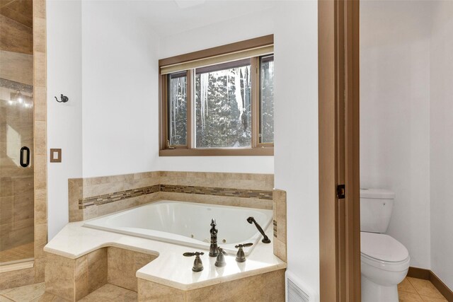 303 Wyant Ln, Hamilton, MT 59840 - full bath featuring toilet, tile patterned flooring, a jetted tub, and a stall shower