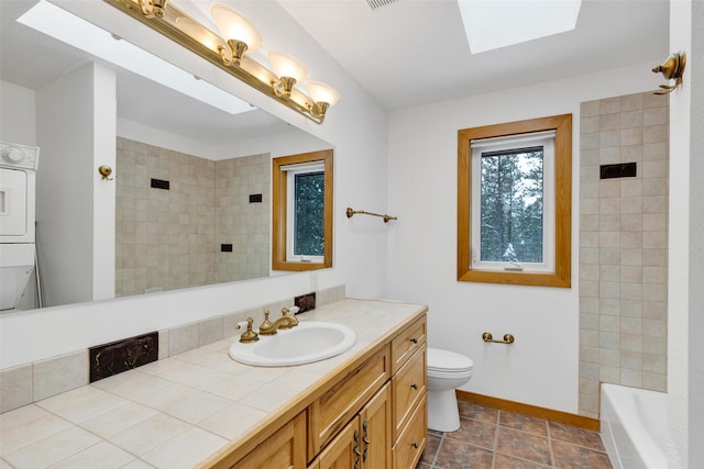 303 Wyant Ln, Hamilton, MT 59840 - full bathroom with a skylight, a shower, toilet, baseboards, and vanity