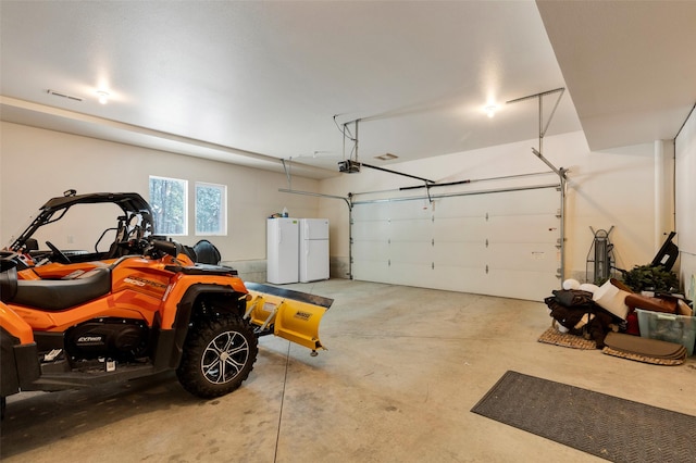 303 Wyant Ln, Hamilton, MT 59840 - garage with freestanding refrigerator and a garage door opener
