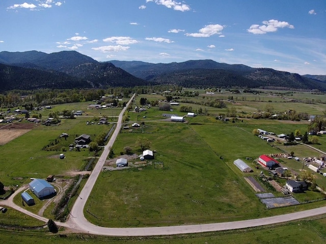 aerial view of property and surrounding area with a mountainous background and rural landscape