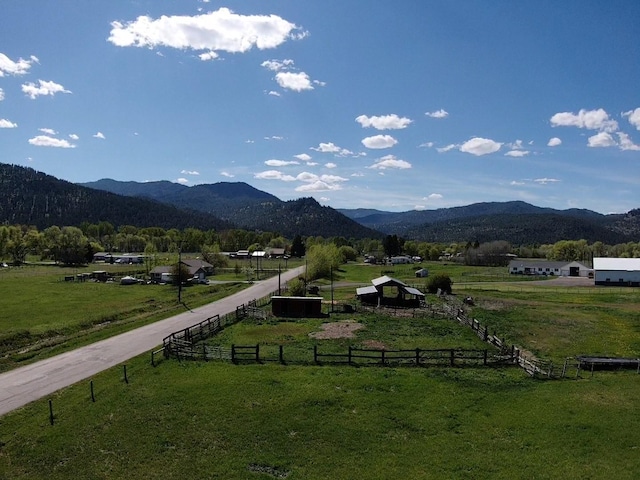 view of mountain backdrop with rural landscape and agricultural land