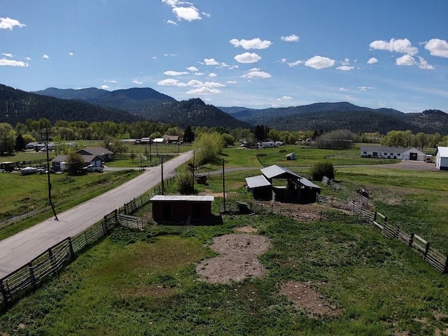 view of mountain backdrop featuring rural landscape and a pastoral area