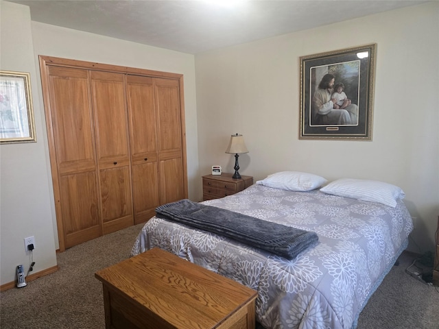 carpeted bedroom with a closet and baseboards
