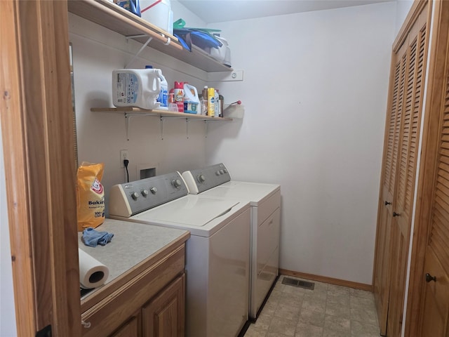 washroom with washing machine and clothes dryer and baseboards