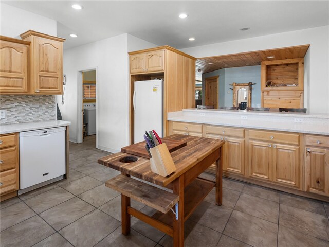 kitchen with white appliances, washer / clothes dryer, light brown cabinetry, recessed lighting, and decorative backsplash