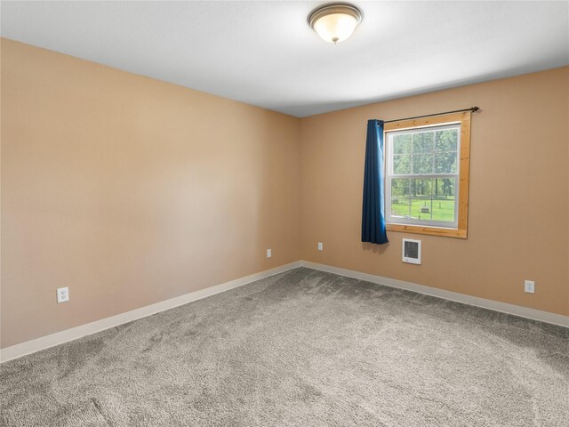 carpeted empty room with baseboards and heating unit