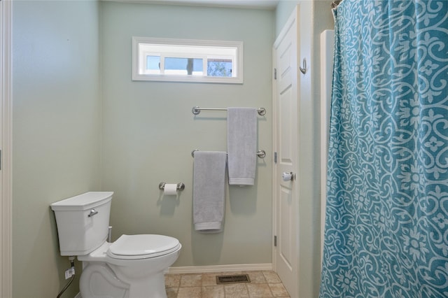 bathroom with baseboards, toilet, and a shower with shower curtain