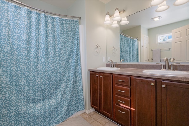 full bathroom with double vanity and tile patterned flooring
