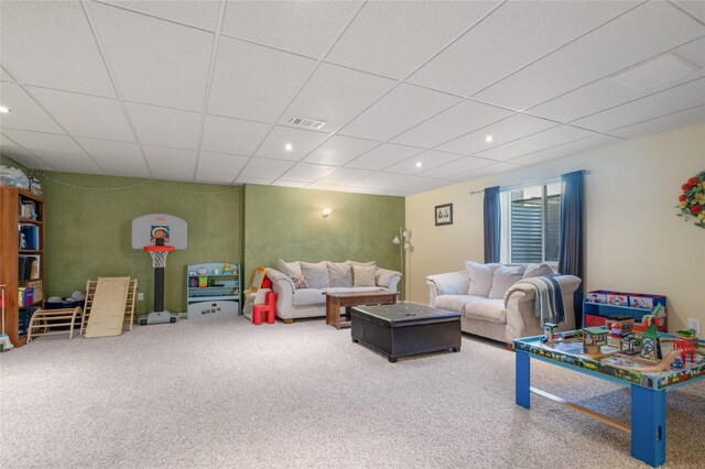 living area with a drop ceiling, carpet flooring, and recessed lighting