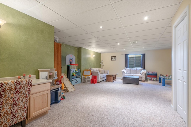 recreation room with carpet and a drop ceiling