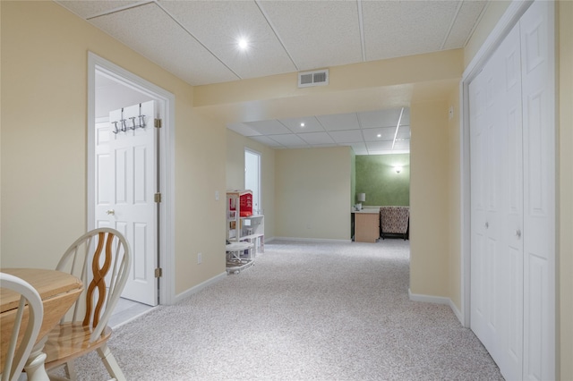 hallway with carpet floors, baseboards, a paneled ceiling, and recessed lighting