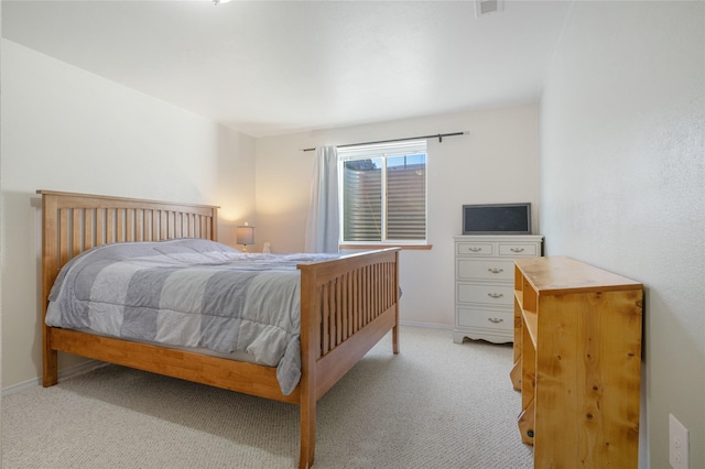 bedroom featuring light colored carpet and baseboards