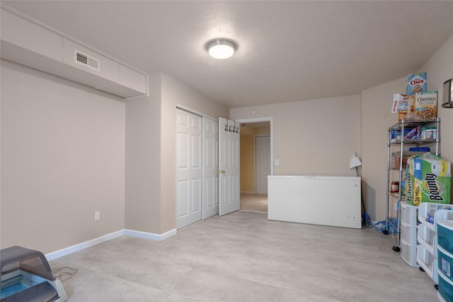 rec room with concrete floors and baseboards