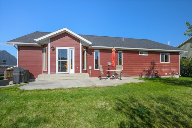 back of house featuring a patio area and a yard
