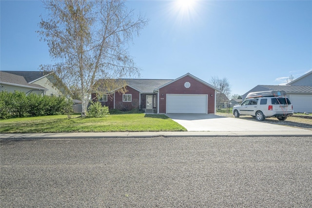 view of front of house featuring an attached garage, driveway, and a front lawn