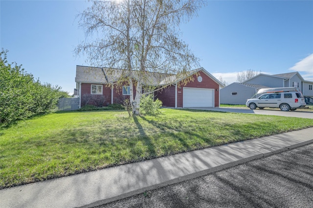 ranch-style house featuring asphalt driveway, a garage, and a front yard