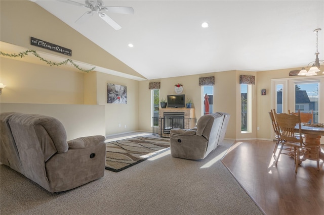 living area with baseboards, ceiling fan, a fireplace with flush hearth, recessed lighting, and high vaulted ceiling